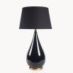 A luxurious black lacquered side lamp with a linen lampshade and brass details