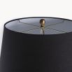 A luxurious black lacquered side lamp with a linen lampshade and brass details