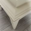Pale grey table with four solid legs and a bordered top surface