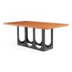 The Coliseum Dining Table features a cork table top supported by ebonized oak arches, blending modern design with organic materials and seating up to eight.