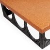 The Coliseum Dining Table features a cork table top supported by ebonized oak arches, blending modern design with organic materials and seating up to eight.