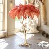 Modern ostrich feather floor lamp with a gold base