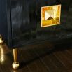 A luxurious, contemporary cabinet with glossy black lacquer and acrylic and brass accents 