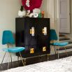 A luxurious, contemporary cabinet with glossy black lacquer and acrylic and brass accents 