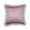 A pink fringed cushion with art deco inspired floral motifs