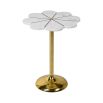 A glamourous floral inspired side table with a white marble flower shaped top and a brushed brass base