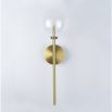 Contemporary natural brass wall lamp with large clear glass lampshade