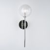 Contemporary industrial wall lamp in polished nickel finish with a large clear glass sphere lampshade