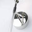 Contemporary industrial wall lamp in polished nickel finish with a large clear glass sphere lampshade