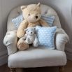 A lovely light blue children's cushion with a fun and playful pattern finished with white piping