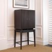 A luxurious mid-century modern bar cabinet with a ribbed design in charcoal grey