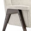 A luxurious armchair with a weave upholstery and stained beech finish