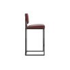 A luxurious modern counter stool with a minimal black metal frame and natural leather upholstery