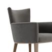 A chic modern mid-century modern dining armchair with wooden legs