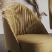 Elegant, modern luxury dining chair with back seat pleating, black legs and gold accents