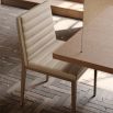 A contemporary natural leather dining chair with retro undertones