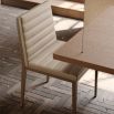 A contemporary natural leather dining chair with retro undertones