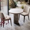 A luxury dining chair by Domkapa with a sophisticated upholstery and opulent wooden legs