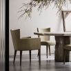 A glamorous modern dining chair with velvet upholstery and wooden legs
