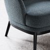 A timeless and sophisticated armchair by Domkapa with a boucle upholstery and black ash base