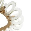 Playful pendant fashioned with clear glass hoops and exposed bulbs that surround a circular framework of antique brass iron
