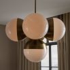 5 orb cluster chandelier with ribbed brass details and spherical shades