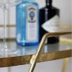 modern drinks trolley with gold frame and gold castor feet