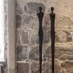 Sleek metal sculpture of a human-like silhouette, in black finish. Floor standing size