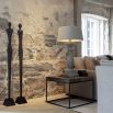 Sleek metal sculpture of a human-like silhouette, in black finish. Floor standing size