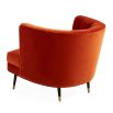 A luxury armchair by Jonathan Adler with a gorgeous red upholstery and beautiful brass capped feet
