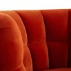A luxury armchair by Jonathan Adler with a gorgeous red upholstery and beautiful brass capped feet