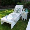 A tropic outdoor cushion with fringe details.