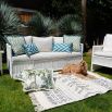 A tropic outdoor cushion with fringe details.