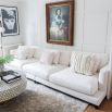 A contemporary white sofa with contrasting black legs 