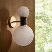 Wall sconce with two contrasting size spheres and black and gold accents