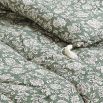 cosy quilt with floral details and tassels
