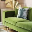 Unique green velvet sofa with fluted oversized arms and gold capped feet