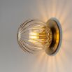 Wall sconce with spherical crystal like shade