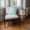 A stylish accent chair by Eichholtz with a brown finished frame and beautiful boucle cream upholstery 