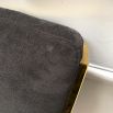 A chic gold barstool with black velvet upholstery
