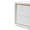 A sleek bedside table by Liang & Eimil with a white finish and brushed brass details