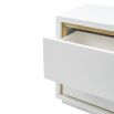 A sleek bedside table by Liang & Eimil with a white finish and brushed brass details