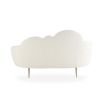 A luxurious cloud-shaped sofa with boucle upholstery and polished brass legs