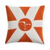 White cushion with orange sun detail