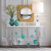 A stylish polished nickel console with emerald acrylic cabochons and marble top