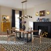 The Coliseum Dining Table features a cork table top supported by ebonized oak arches, blending modern design with organic materials and seating up to eight.