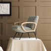 The Gainsbourg Lounge Chair is a vintage-inspired piece with a cushy seat, cerused ash wood arms, and blackened metal legs, perfect for pairing with a sofa.