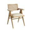 A stylish, Scandinavian-inspired upholstered armchair with a caned back rest