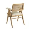 A stylish, Scandinavian-inspired upholstered armchair with a caned back rest