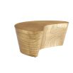 Coffee table in natural, curved silhouette in antique brass finish.